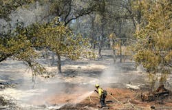A firefighter extinguishes hotspots along a hillside during the French fire in Mariposa, California on Friday. A firefighter extinguishes hotspots along a hillside during the French fire in Mariposa, California on Friday.