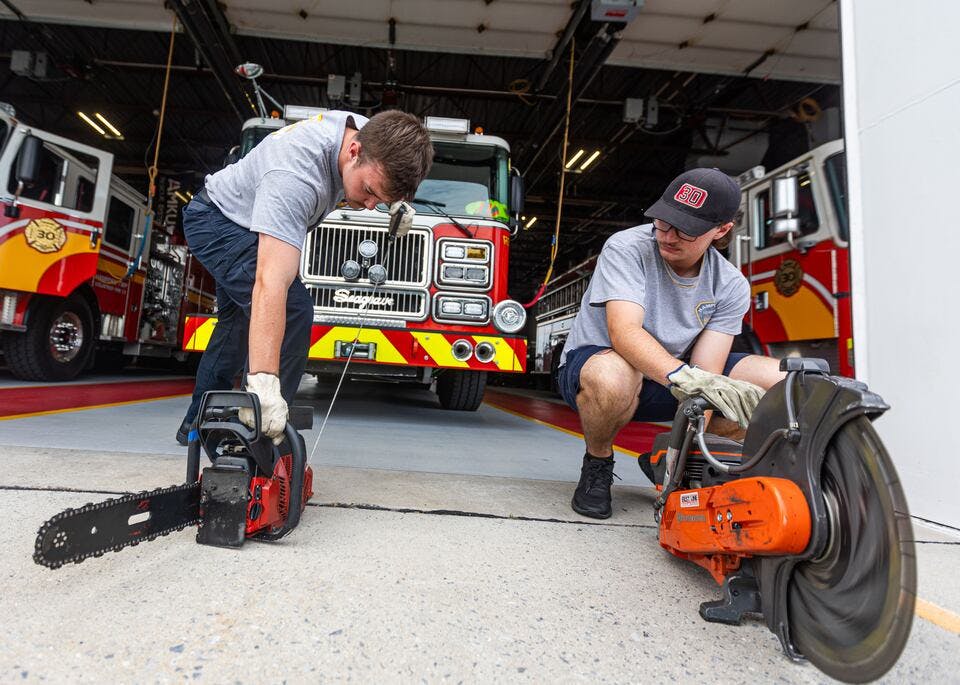 Hampden Township volunteer firefighters Dalton Forsyth (left) and Justin Taylor test saws.