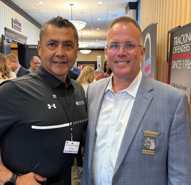 From left, Henry Reyna is pictured with Matthew Saxton, the CEO and executive director of Michigan Sheriff's Association, at the annual conference for Michigan sheriffs earlier this summer in Bellaire, Michigan.