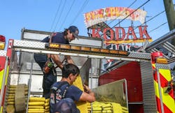 Atlanta firefighters pack up hose after a building fire. Atlanta firefighters pack up hose after a building fire.