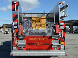 The rear hosebed on each engine carries 1,000 feet of 5-inch hose, two preconnected 250-foot-long 1¾-inch hoselines and two beds of 2½-inch hose for additional heavy stream lines. Note the fixed aluminum steps to provide safe access to the rear hosebed. The rear hosebed on each engine carries 1,000 feet of 5-inch hose, two preconnected 250-foot-long 1¾-inch hoselines and two beds of 2½-inch hose for additional heavy stream lines. Note the fixed aluminum steps to provide safe access to the rear hosebed.