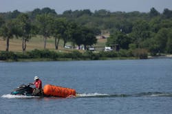 A jet skier pulls in buoys from the CrossFit Games at Marine Creek Lake in Fort Worth where athlete Lazar Đukić drowned. A jet skier pulls in buoys from the CrossFit Games at Marine Creek Lake in Fort Worth where athlete Lazar Đukić drowned.