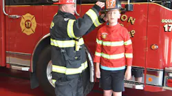 Jaxon Aldridge and Firefighter Sean Joyce of the Aston Township, PA, Fire Department’s (ATFD) exchange hats as they talk about what real firefighters wear.