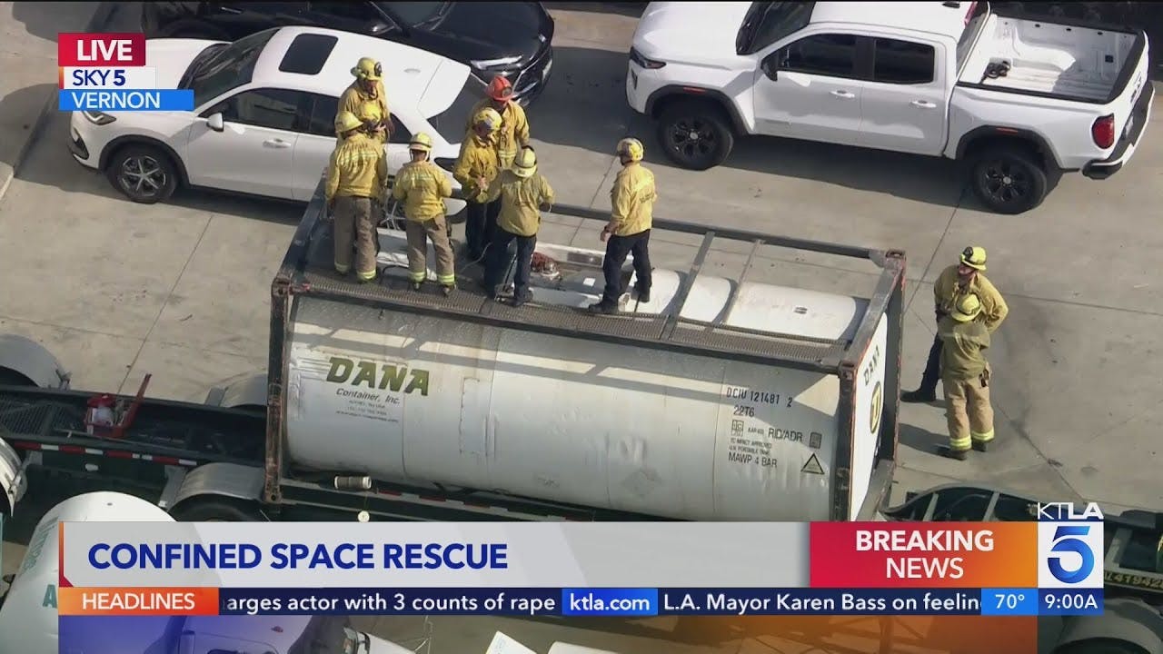 Fire crews rescue two that fell into container truck