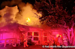 Firefighters found the rear of the Fort Worth home engulfed in flames late Saturday night.