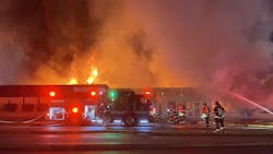 Firefighters found heavy fire in the one-story commercial building late Saturday night, which spread to an adjacent home. Firefighters found heavy fire in the one-story commercial building late Saturday night, which spread to an adjacent home.