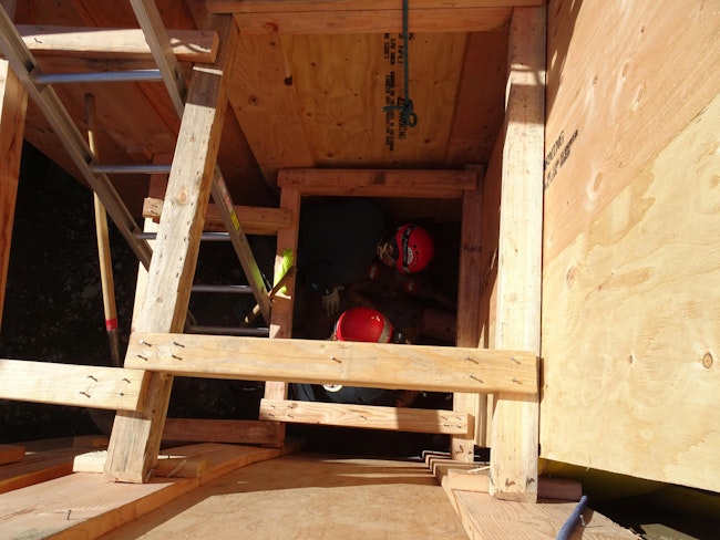 Trenching regulations require rescuers to provide egress for rescue technicians who are in the trench whenever the trench is at least four feet deep.