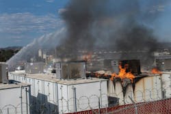 Firefighters apply water as fire burns through a lithium battery storage container at the San Diego Gas and Electric N.E. Operations Center in Escondido. Firefighters apply water as fire burns through a lithium battery storage container at the San Diego Gas and Electric N.E. Operations Center in Escondido.