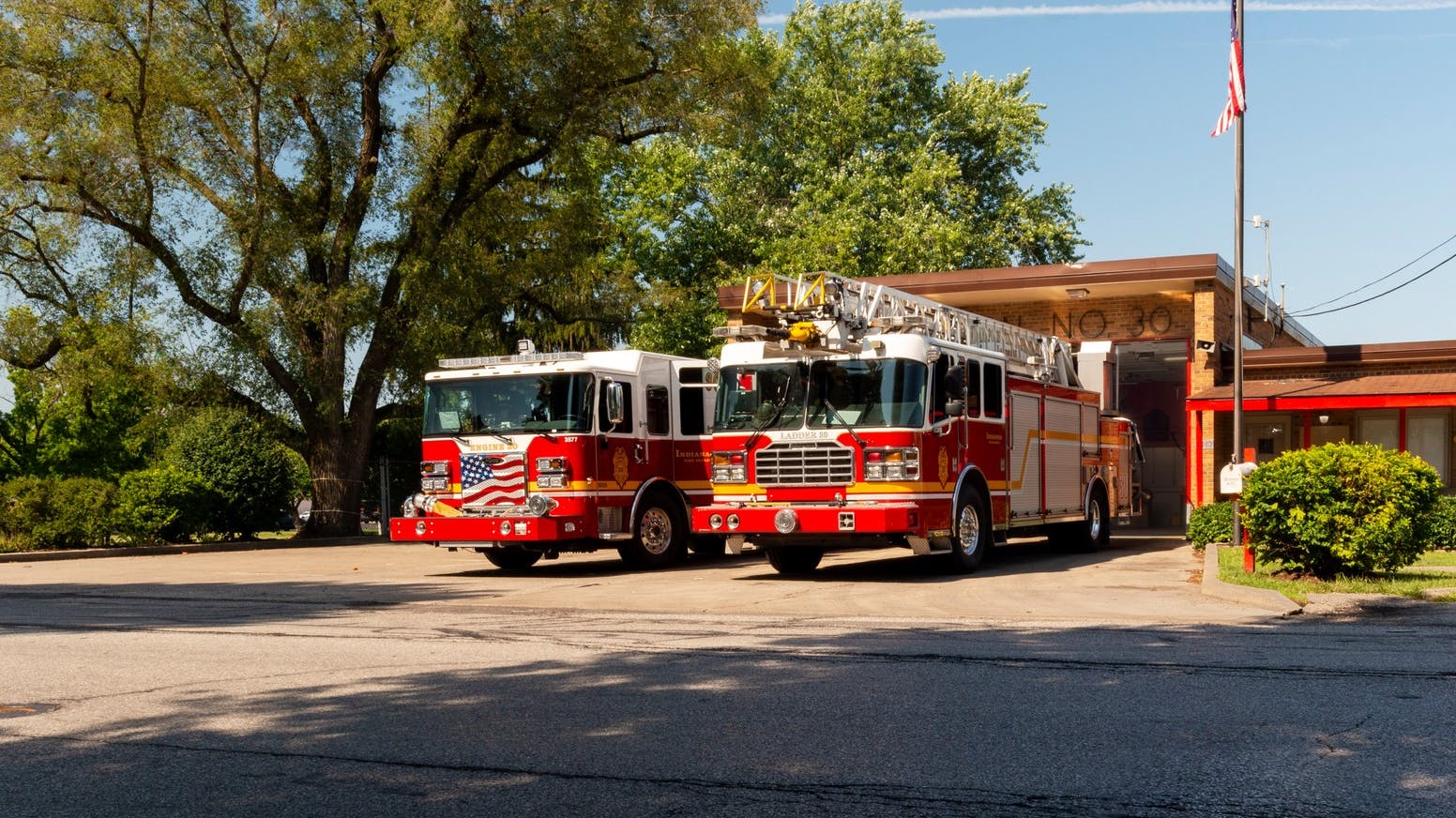 Two firefighters from Indianapolis were struck by a car, with one going airborne and the second being pinned by the car Saturday morning.