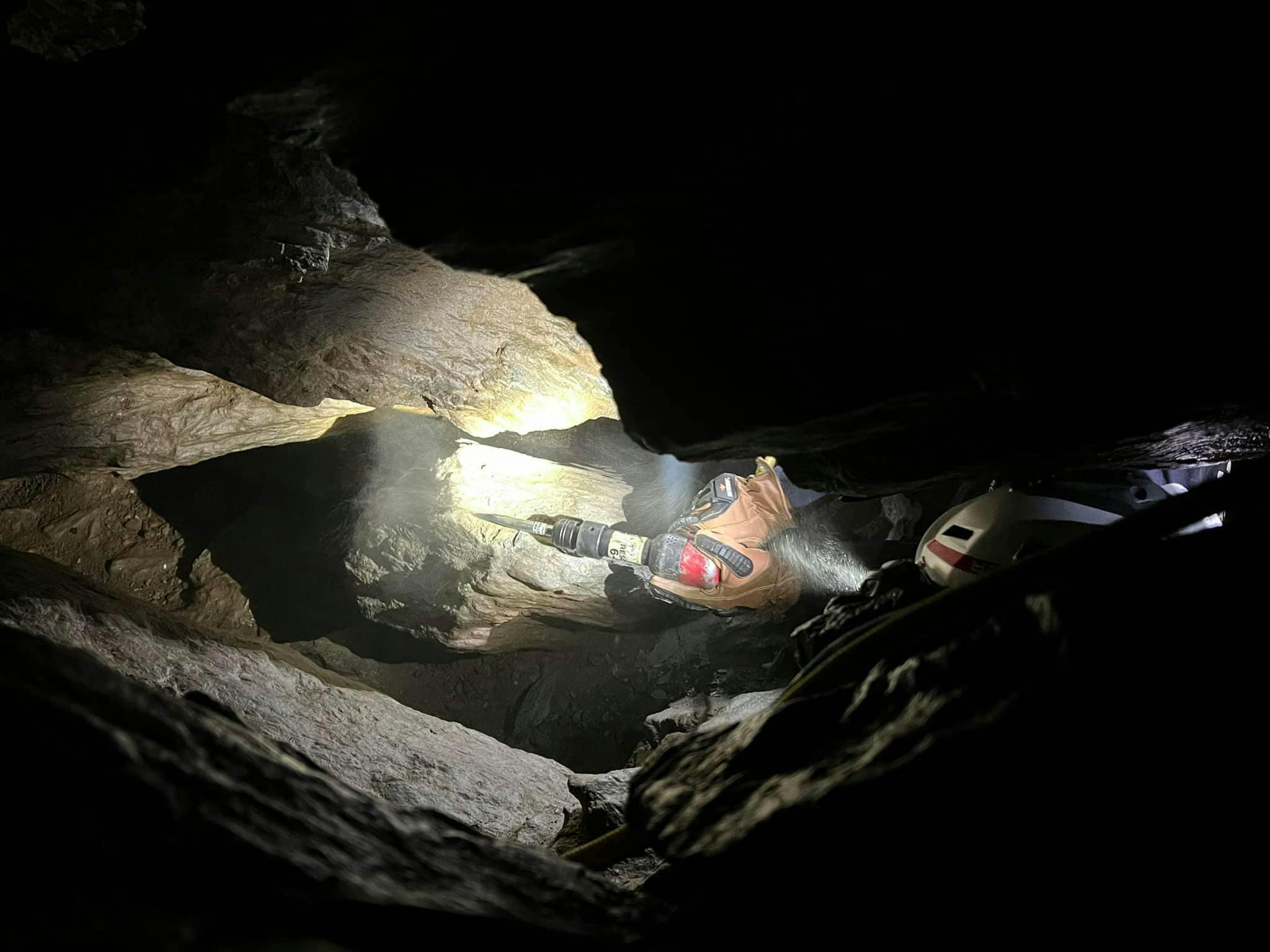 A technician uses a chisel during the cave rescue operation.