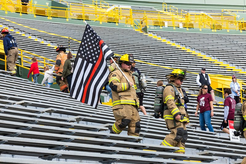 Climbers varied from wearing full turnout gear to masks to carrying flags.
