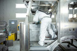 A worker paints part of a cab in the early production stages of a new Pierce fire apparatus. A worker paints part of a cab in the early production stages of a new Pierce fire apparatus.