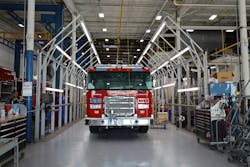 Workers in the light tunnel area, which is exclusively made for buffing out any scratches before the truck goes to the blue floor. Workers in the light tunnel area, which is exclusively made for buffing out any scratches before the truck goes to the blue floor.