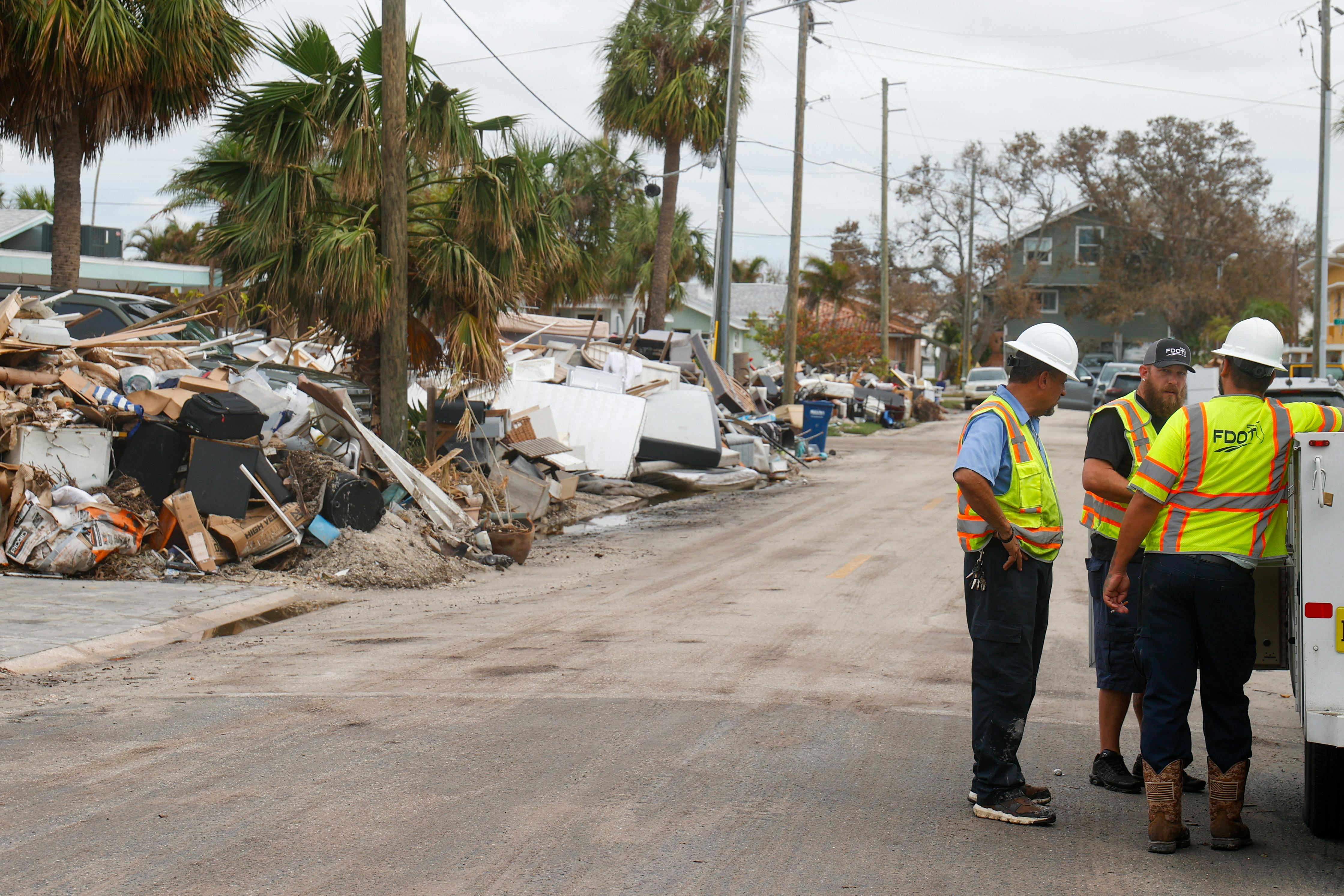 Florida Department of Transportation workers assess the damage to homes following Hurricane Helene.