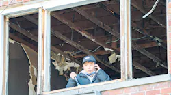 An FDNY investigator examines the Bronx fire scene where a lithium-ion battery sparked a deadly fire.