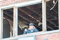 An FDNY investigator examines the Bronx fire scene where a lithium-ion battery sparked a deadly fire. An FDNY investigator examines the Bronx fire scene where a lithium-ion battery sparked a deadly fire.