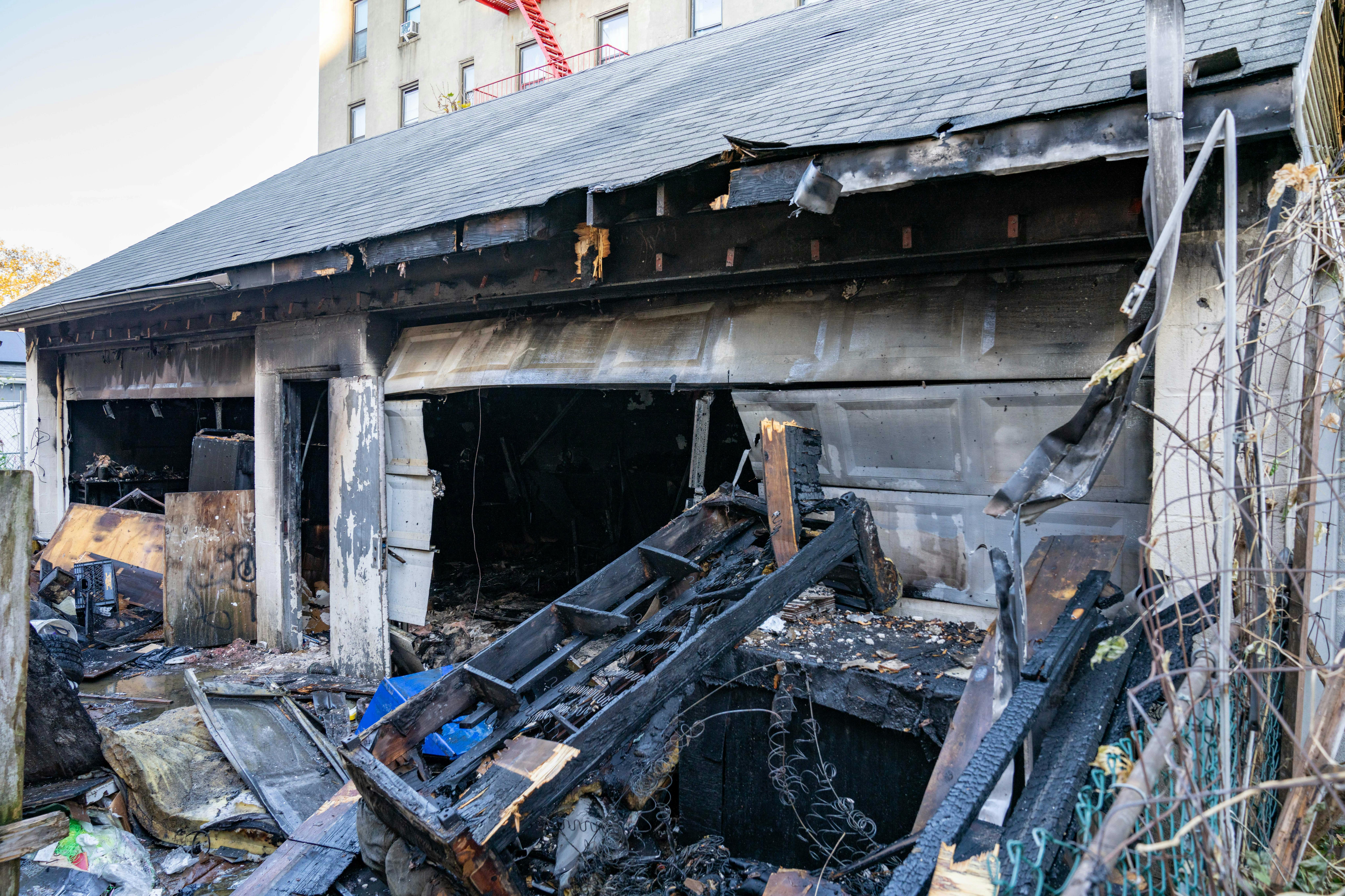 An unidentified man and an unidentified woman, who were living in a Queens garage, were found dead after a fire Saturday morning.