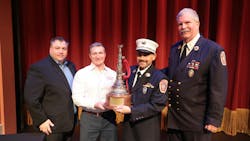 Freeport firefighter Petros Mestheneas (second from right) received the Michael O. McNamee Award of Valor at FireFusion for his rescue efforts of two firefighters. He receievd the award from FireFusion Conference Director Peter Matthews (left to right), Robert Daus Jr. from Liberty Artworks and Freeport Fire Department Executive Director Ray Maguire. Freeport firefighter Petros Mestheneas (second from right) received the Michael O. McNamee Award of Valor at FireFusion for his rescue efforts of two firefighters. He receievd the award from FireFusion Conference Director Peter Matthews (left to right), Robert Daus Jr. from Liberty Artworks and Freeport Fire Department Executive Director Ray Maguire.