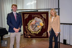 Museum President George Getz and his mother, Diane, standing in front of the flag. Museum President George Getz and his mother, Diane, standing in front of the flag.