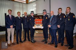 Officials from Germany, the United States and the Hall of Flame Museum display the fire siren from that was gifted from Germany. Officials from Germany, the United States and the Hall of Flame Museum display the fire siren from that was gifted from Germany.