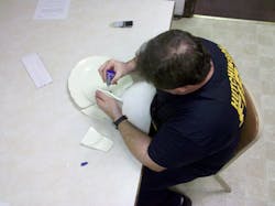 A firefighter from the Hutchinson Fire Department attempting to fix the lore-filled turkey platter. A firefighter from the Hutchinson Fire Department attempting to fix the lore-filled turkey platter.