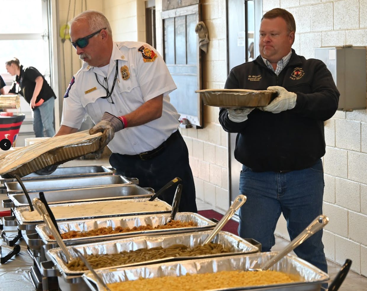 Wylie Fire Rescue preparing the layout of food for the Thanksgiving event.
