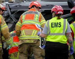 Lubbock firefighters and EMS personnel wear helmets to protect their heads at a crash scene following the deaths of two firefighters and a police officer in 2020. Lubbock firefighters and EMS personnel wear helmets to protect their heads at a crash scene following the deaths of two firefighters and a police officer in 2020.