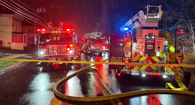 The scene outside the Syracuse house fire Saturday night where firefighters rescued a victim.