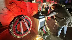 A retired firefighter touches the memorial for the Worcester Cold Storage Fire after the 25th anniversary memorial service.