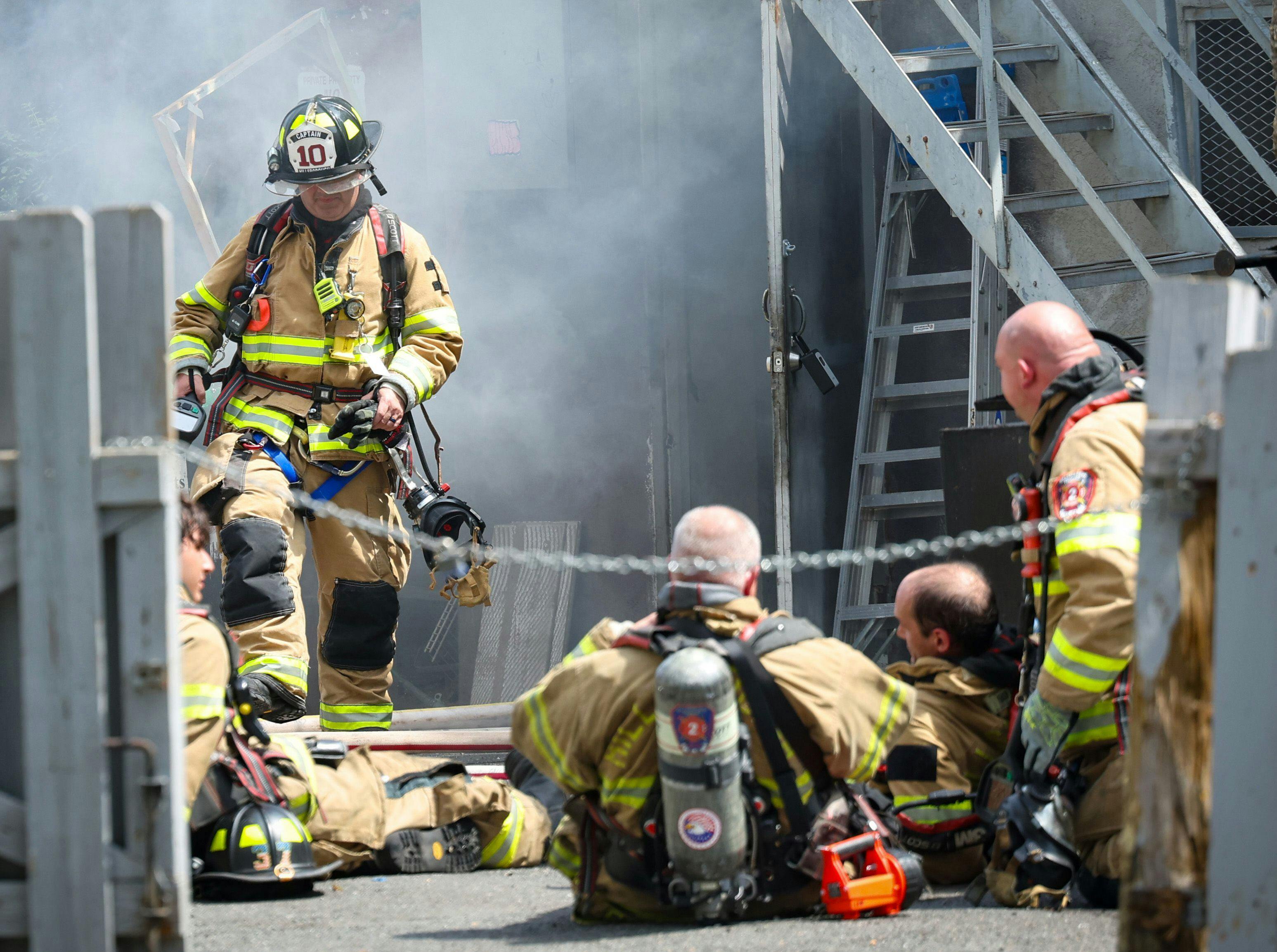 Hillsborough firefighters retreat from the roof as they battled a multiple-alarm structure fire in a restaurant in June.