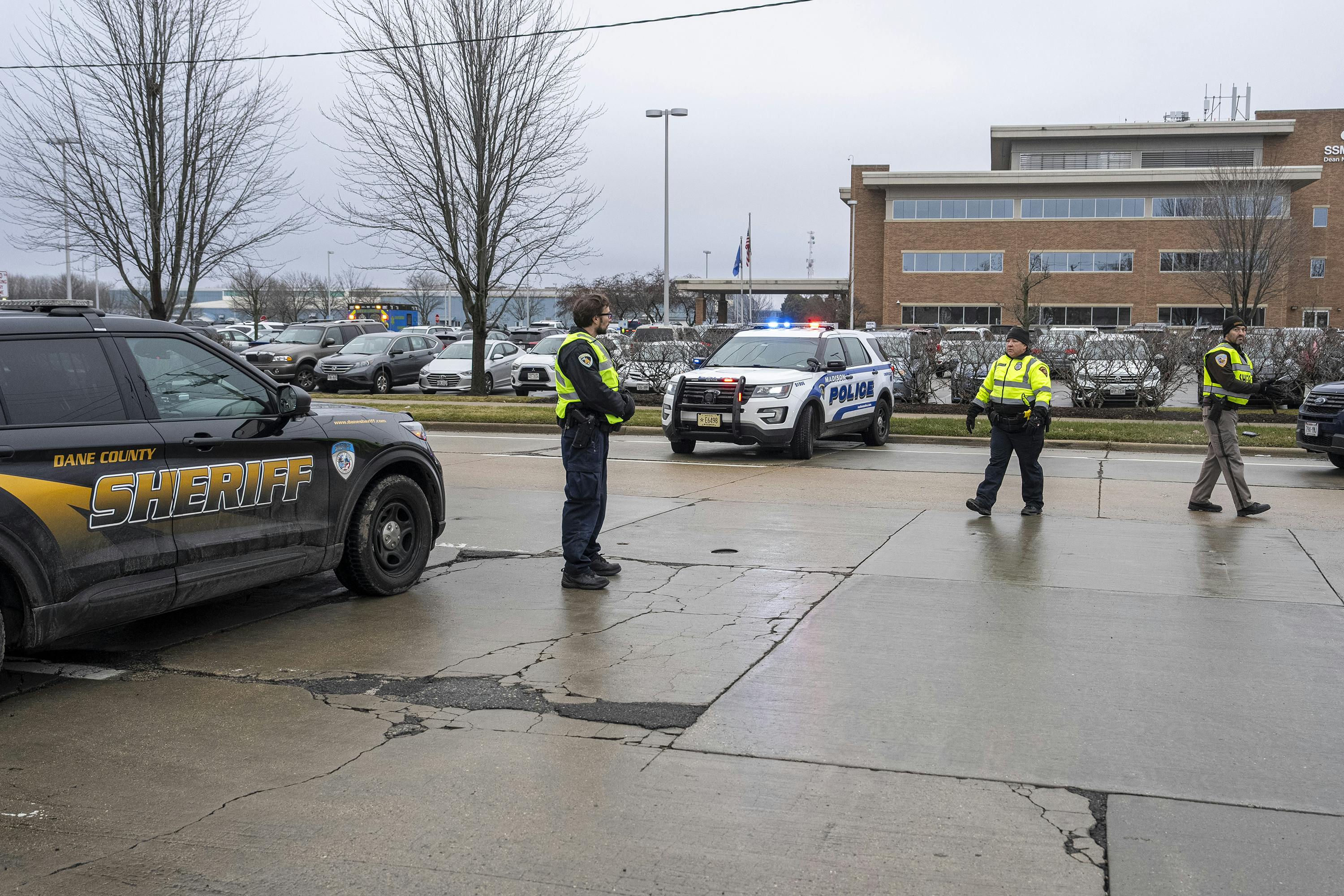Law enforcement officials near a health care clinic where students from Abundant Life Christian School in Madison, WI, will be reunited withe their parents after a school shooting on Dec. 16, 2024,