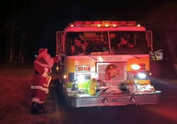 Santa getting gifts from the Pittsville, MD, Volunteer Fire Department's apparatus. Santa getting gifts from the Pittsville, MD, Volunteer Fire Department's apparatus.