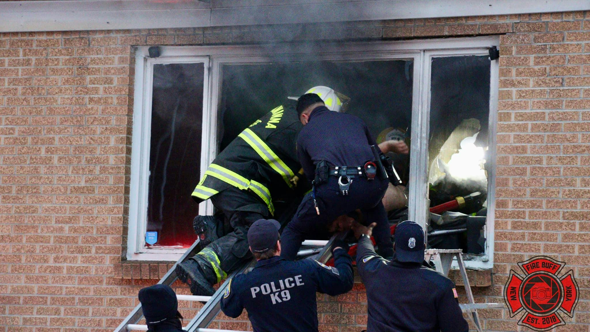 Lackawanna firefighters and police work to remove a victim from a Christmas morning house fire.