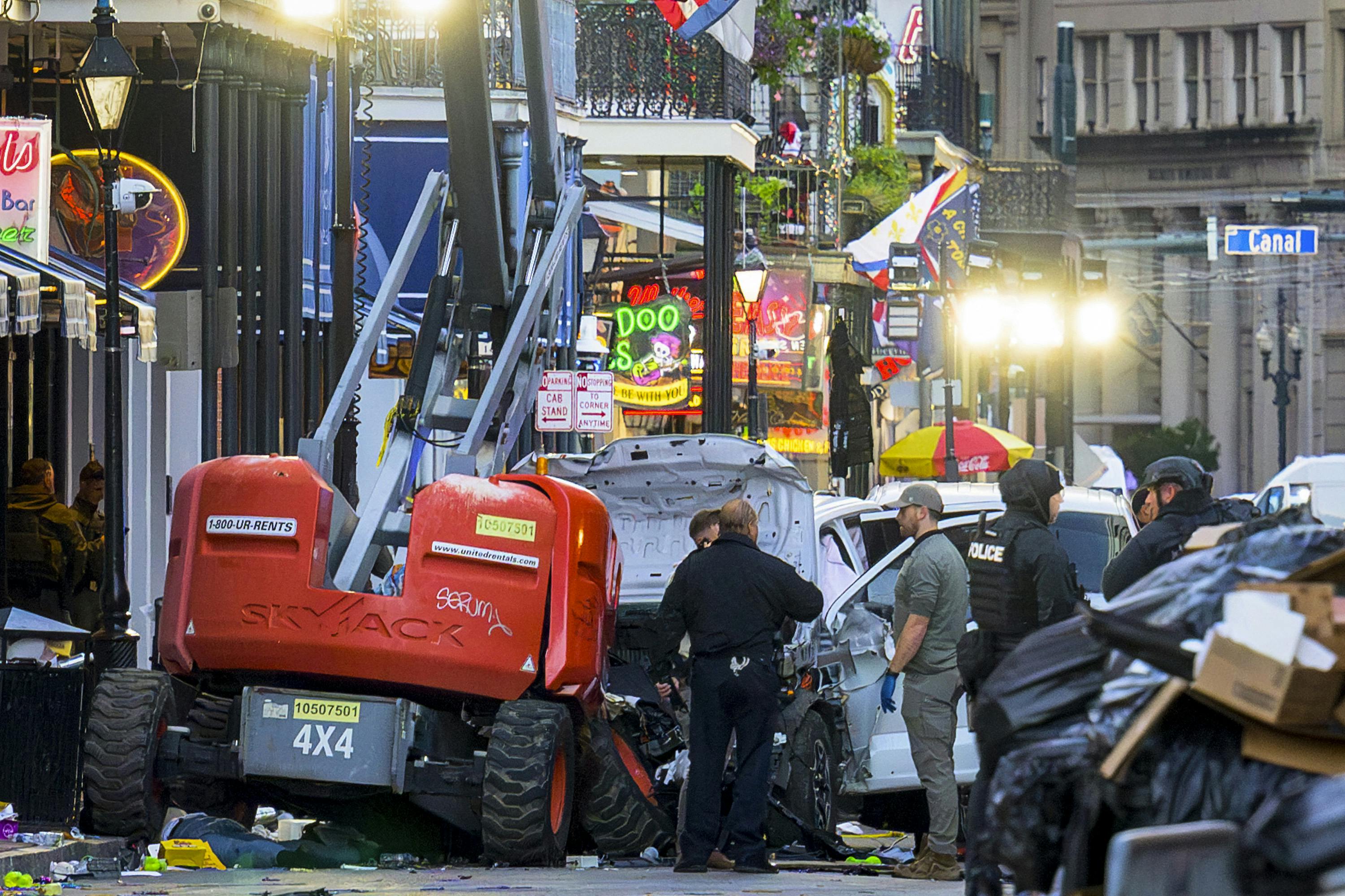 Law enforcement officers investigate a mass shooting in New Orleans that left 10 dead and 35 hurt.