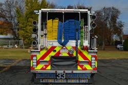 The hosebed on Neptune Fire Company’s Engine 33 carries 1,900 feet of 5-inch hose in split beds, three preconnected attack lines and 2½-inch hose. Note the layout strap on the supply line and the location of the rear body intake. The hosebed on Neptune Fire Company’s Engine 33 carries 1,900 feet of 5-inch hose in split beds, three preconnected attack lines and 2½-inch hose. Note the layout strap on the supply line and the location of the rear body intake.