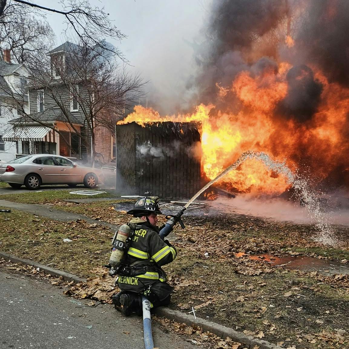 Rochester firefighters worked to protect adjacent homes from intense fire conditions.