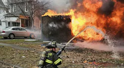 Rochester firefighters worked to protect adjacent homes from intense fire conditions.
