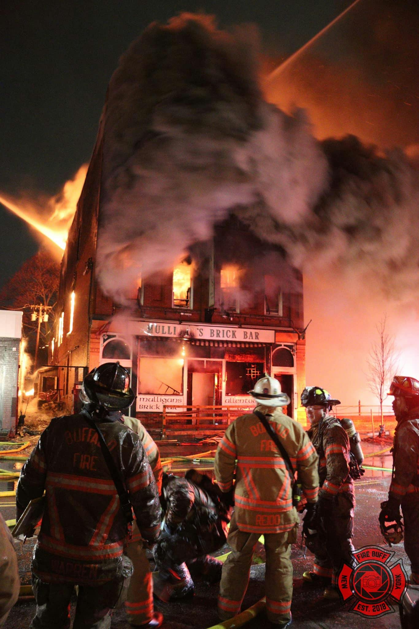 Buffalo firefighters were pulled from the building as flames spread throughout the structure.