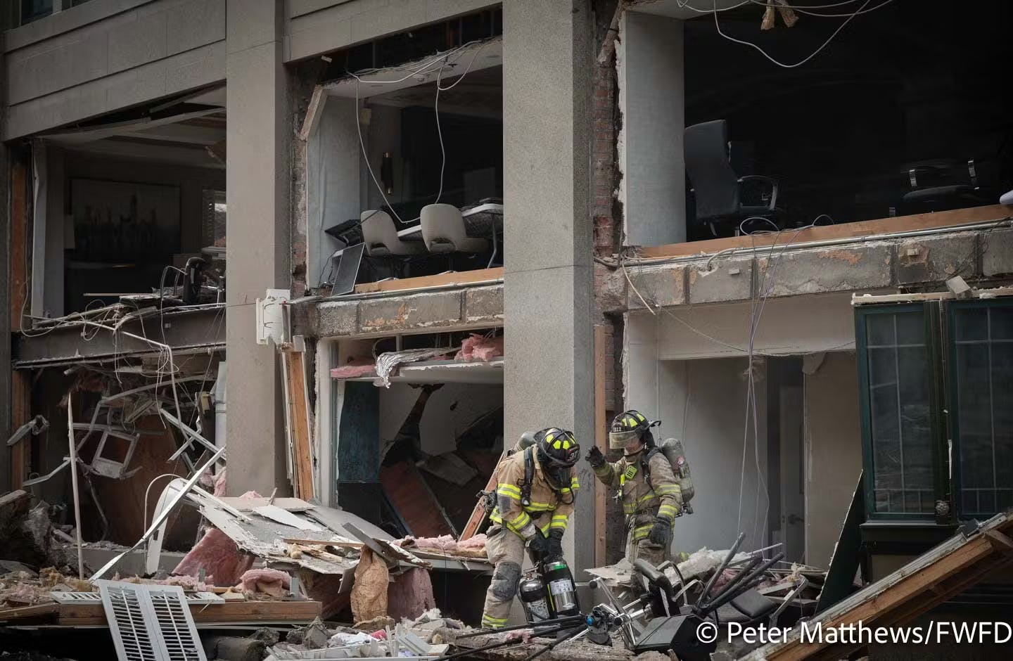 Fort Worth firefighters search through debris after a hotel blast last year.