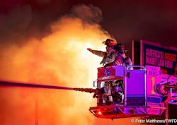 Capt. Gregg Keeton and firefighter Alexis Dunn operate Tower 1's master stream into heavy fire conditions at the vacant building. Capt. Gregg Keeton and firefighter Alexis Dunn operate Tower 1's master stream into heavy fire conditions at the vacant building.