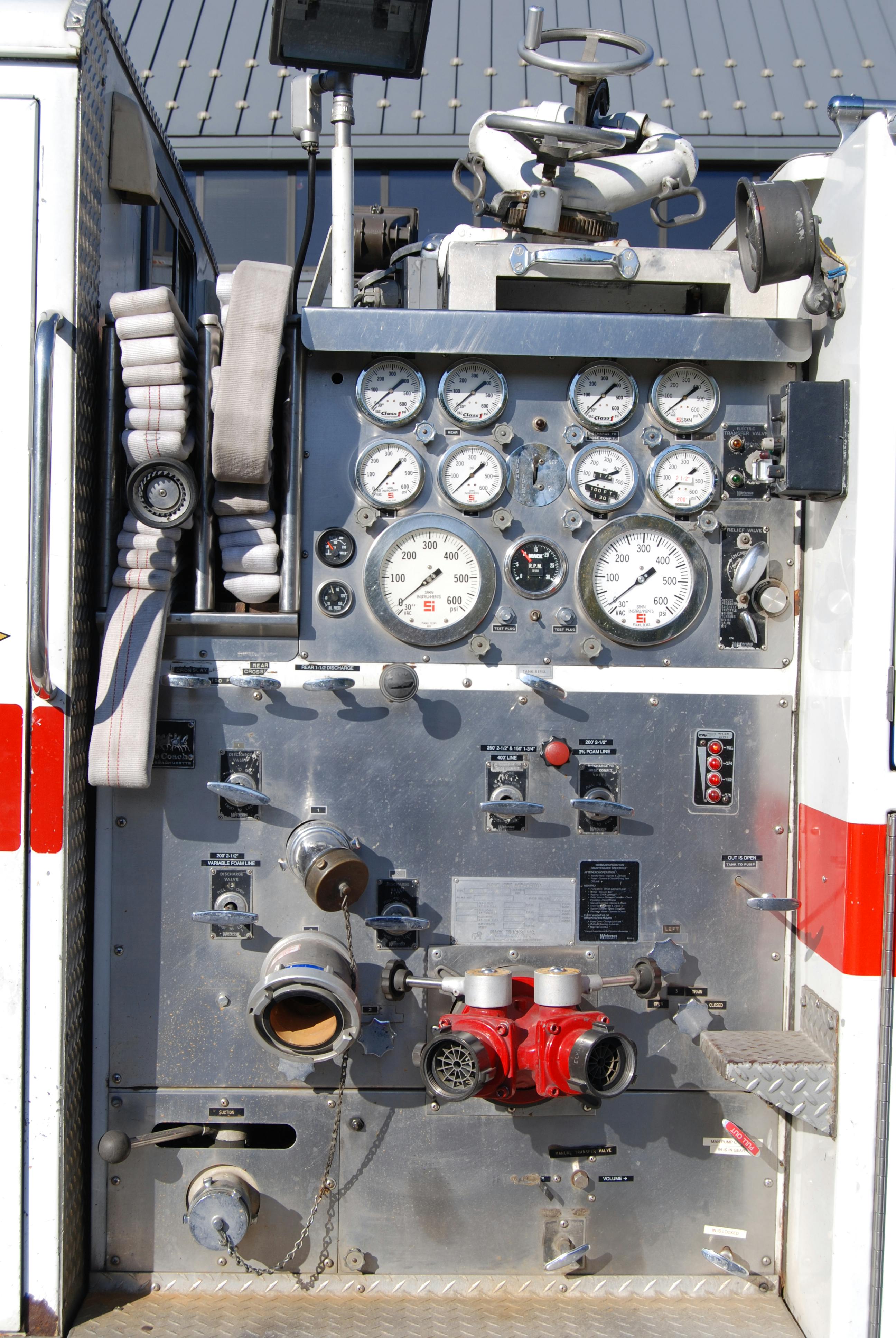 Pump panels from earlier rigs, such as the one on this 1977 Mack CF rig, generally were more compact, with all discharges controlled via direct-acting linkages and pull rods. In later years, NFPA 1901: Standard for Automotive Fire Apparatus was changed to require that a gauge be located adjacent to the respective discharge control. Note the vernier throttle on the lower panel and the discharge relief valve in the upper right panel.