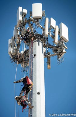 A firefighters gains access to one of the workers who was injured and trapped on the tower. A firefighters gains access to one of the workers who was injured and trapped on the tower.