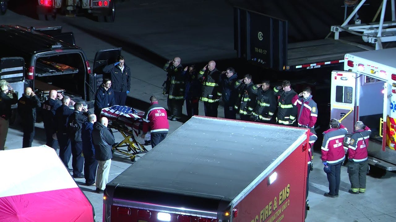 Firefighters Salute as Flag-draped Casket of Helicopter Crew Member