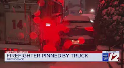 Firefighter pinned between vehicles
