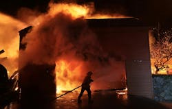 A firefighter battles a house fire during the Palisades Fire on Jan. 8, 2025. A firefighter battles a house fire during the Palisades Fire on Jan. 8, 2025.