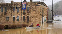 Jordan Wade, left, and Kelvin Gabbard made their way through high flood waters after severe overnight rain hit Beattyville, KY.