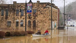 Jordan Wade, left, and Kelvin Gabbard made their way through high flood waters after severe overnight rain hit Beattyville, KY. Jordan Wade, left, and Kelvin Gabbard made their way through high flood waters after severe overnight rain hit Beattyville, KY.