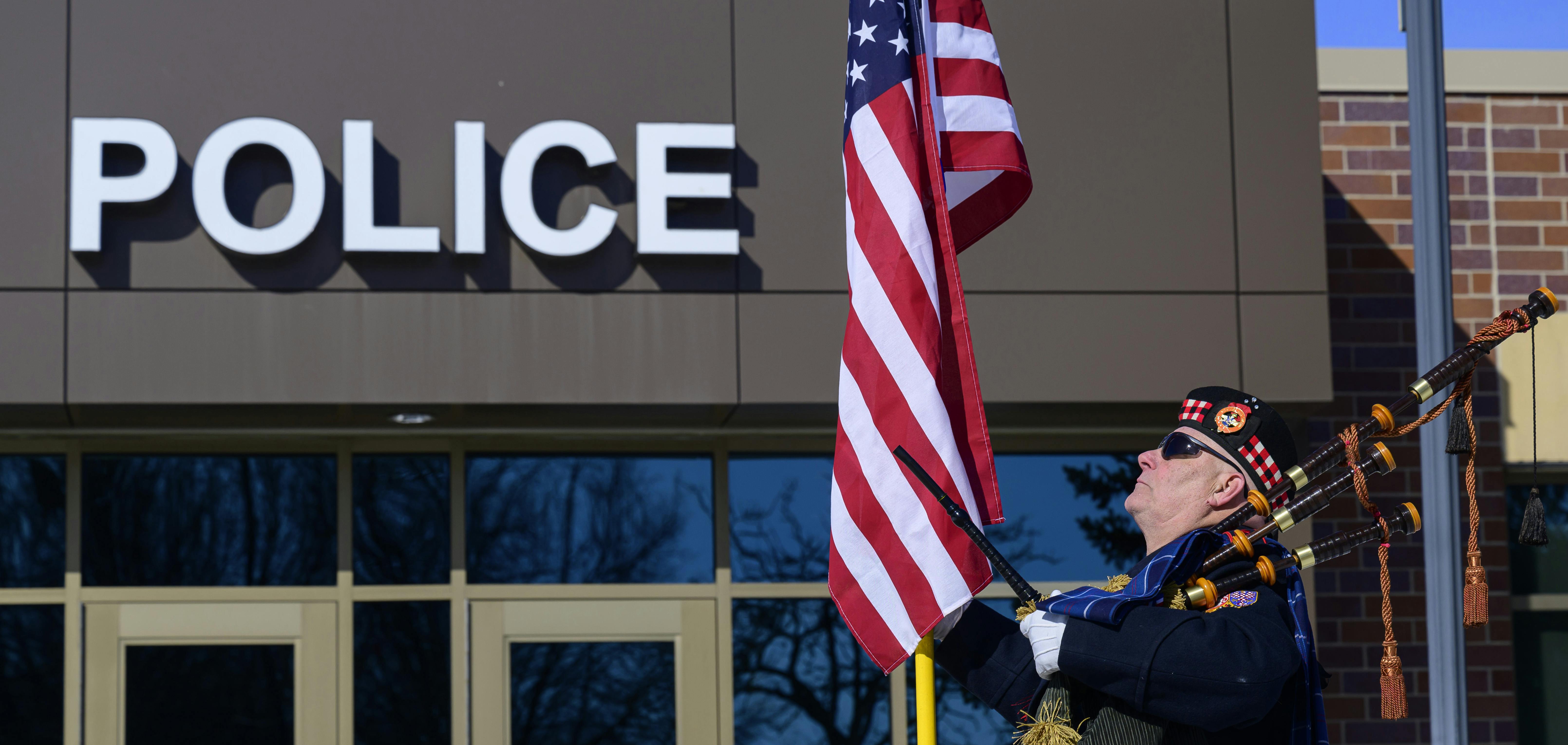 A bagpiper, who didn't identify himself, stood outside the Burnsville Police Department Tuesday, the first anniversary of the deaths of two officers and a firefighter/paramedic.
