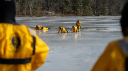 Firefighter practice rescuing each other using the life sling, a piece of equipment that is used to go around victims that have fallen through the ice.