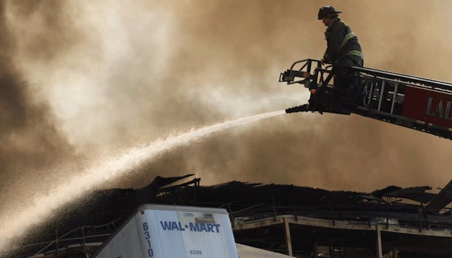 A firefighter battled a 2022 fire at a Walmart warehouse in Plainfield, IN.